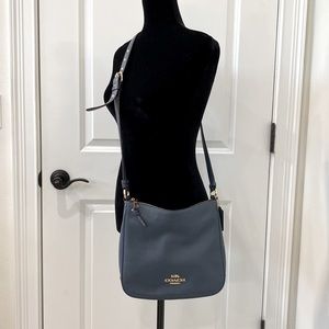 NWOT Coach crossbody bag in dusty blue. Perfect unused condition!